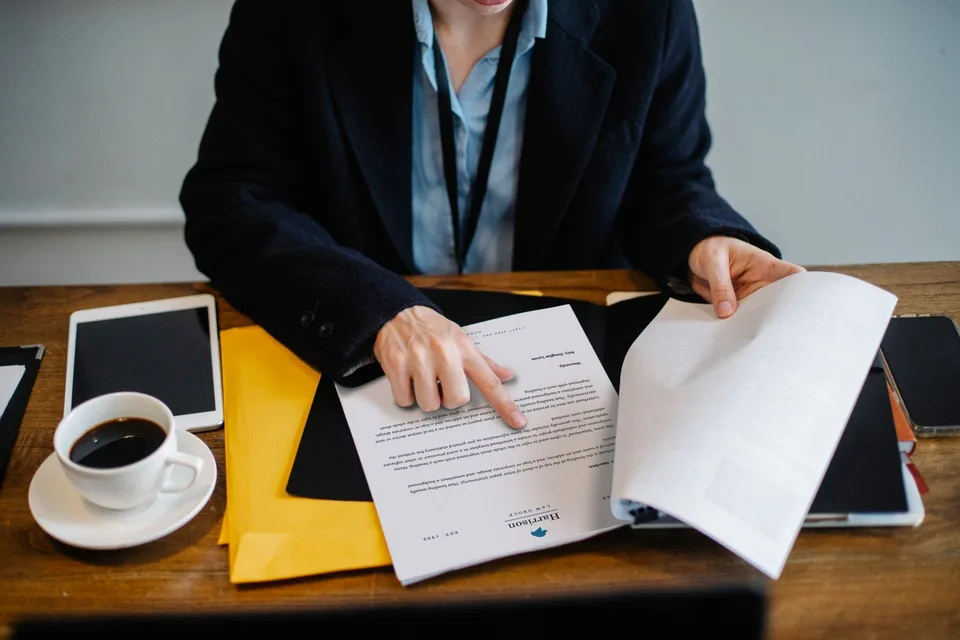 Revisión de documentos en una mesa de trabajo; fotografía editorial